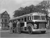 Col. H. M. Grant, Col. Victor Oland, R. W. Harris and Claude Taylor, directors of the Callow Veterans and Invalids Welfare League, inspect the newest addition to their fleet of wheelchair coaches in October 1956. The coach cost $20,000.